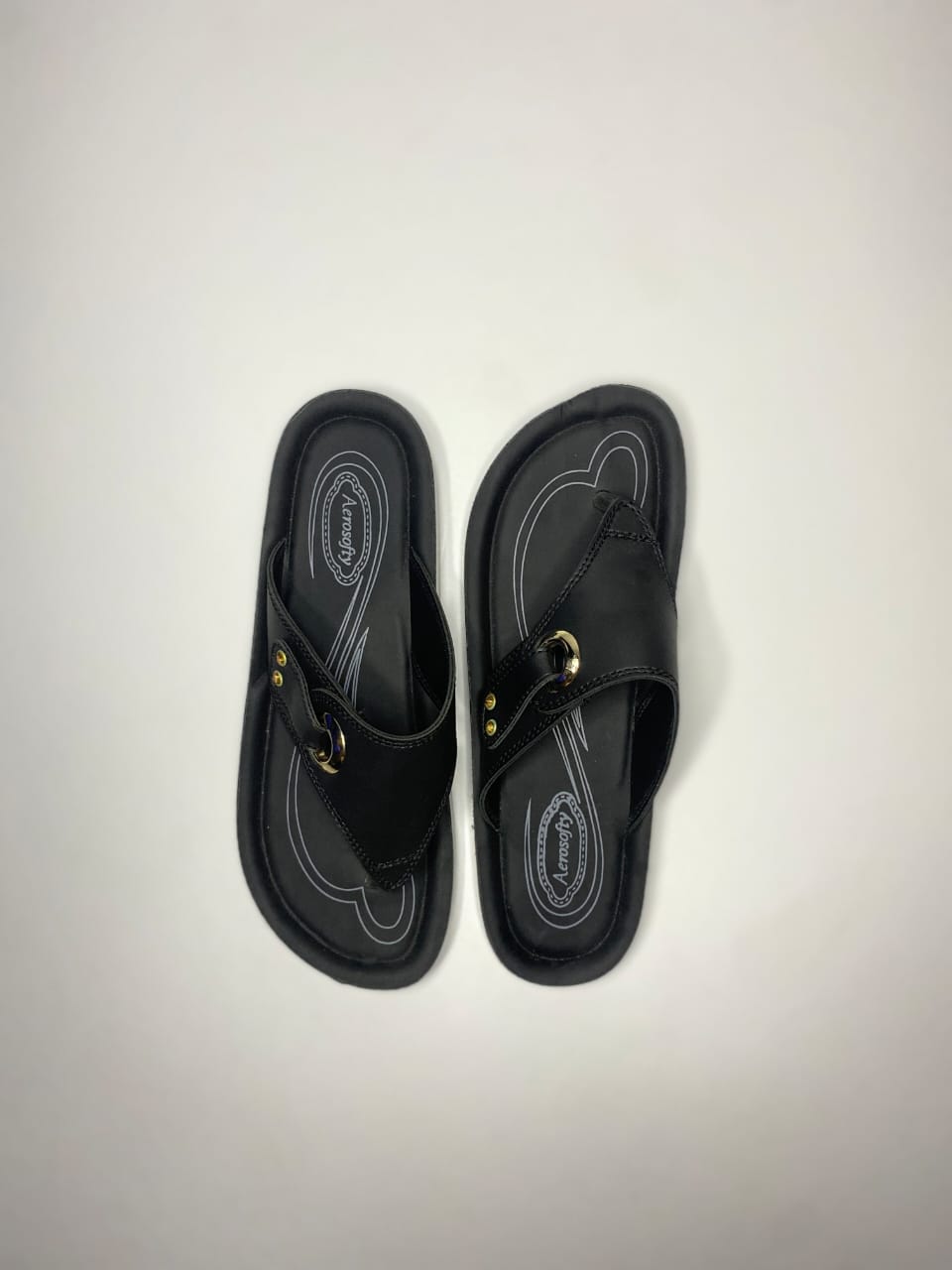 Women’s black slip-on sandals with metallic ring design – comfortable daily wear footwear.