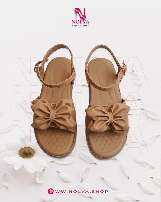 Women’s tan flat sandals with bow detail – comfortable and trendy casual summer footwear.