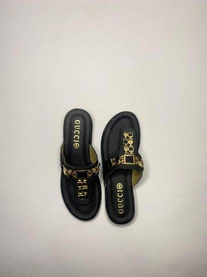 Women’s black sandals with golden embellished strap – stylish festive and party footwear.