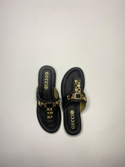 Women’s black sandals with golden embellished strap – stylish festive and party footwear.