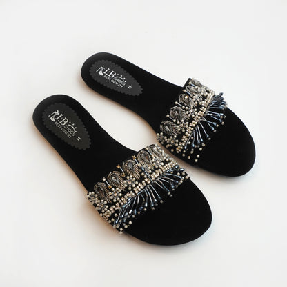Nolva Velvet Shine black velvet sandals with golden and black bead embellishments – luxury flat footwear for women’s party and festive wear